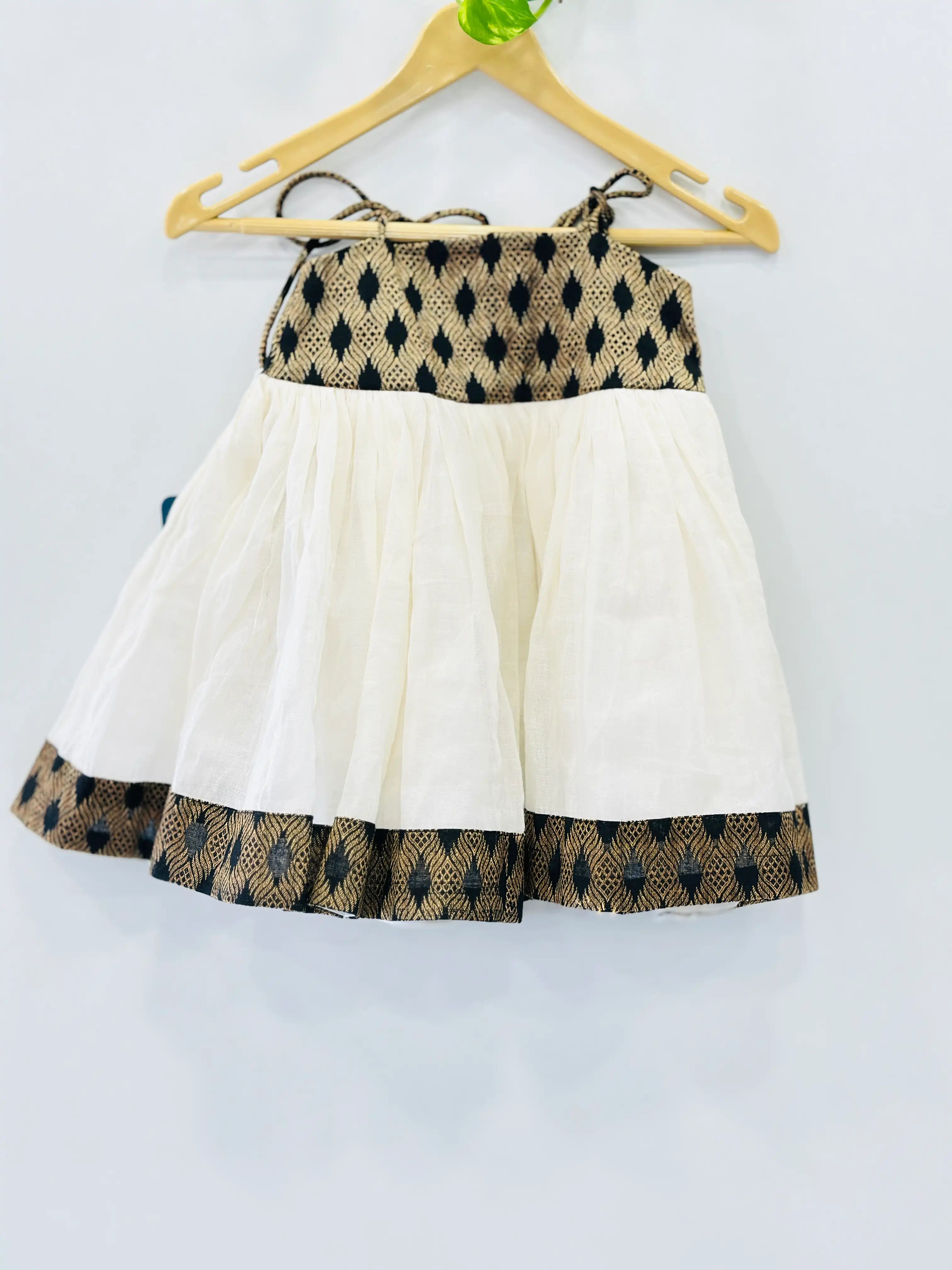 kerala-kasavu-knotted-frock-for-girls-in-india-elegant-cotton-and-brocade-design