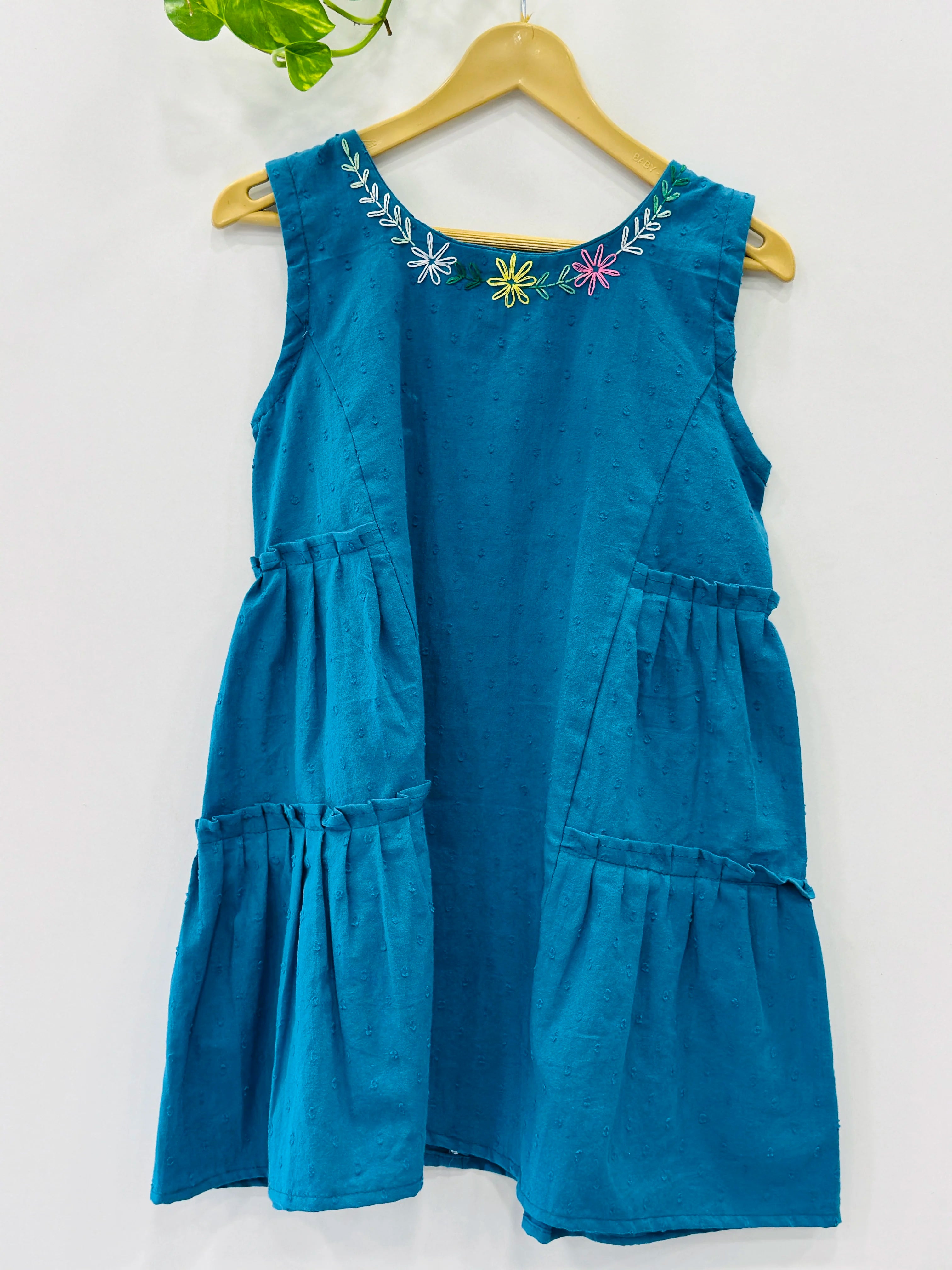 premium-cotton-frock-for-girls-online-sleeveless-blue-frocks-for-kids-in-muslin-fabric-with-colourful-embroidery-and-boat-neck